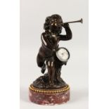 A GOOD SMALL 19TH CENTURY BRONZE CUPID carrying a drum and blowing a horn, standing on a circular