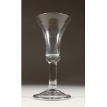 A LARGE 18TH CENTURY WINE GLASS, with inverted bell shaped bowl and plain stem. 8.5ins high.