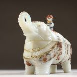 AN UNUSUAL PAINTED OPAQUE GLASS BOX AND COVER, modelled as an elephant. 7ins long.