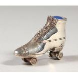 A NOVELTY SILVER ROLLER SKATE PIN CUSHION.