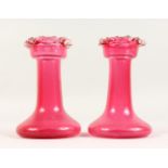 A PAIR OF CRANBERRY GLASS FRILLY EDGE VASES.