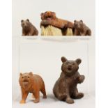A GROUP OF FIVE BLACK FOREST CARVED BEARS, one as a brush. Various sizes.