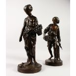 DENIERE. A good pair of bronze figures of a boy and a girl, holding a hatchet and hat, and a