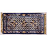 A CHINESE RUG, with three central motifs and blue border. 5ft x 2ft 4ins.
