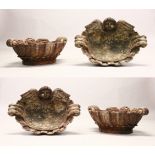 A SET OF FOUR CARVED WOOD SHELL SHAPE BOWLS, with angel head decoration. 1ft 9ins wide.
