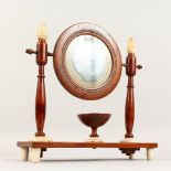 A SMALL 19TH CENTURY BEECH AND ALABASTER CIRCULAR SHAVING MIRROR AND STAND. 13ins high x 12ins