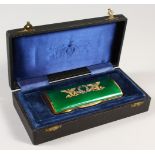 A GOOD RUSSIAN SILVER GILT, GEM SET AND GREEN ENAMEL CASE, in a fitted box. 4.25ins long.