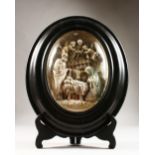 AN OVAL PLASTER MODEL OF THE NATIVITY, framed and glazed. 17ins high x 13.5ins wide.