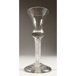 A GEORGIAN WINE GLASS, with air twist stem, inverted bell bowl and firing foot. 6ins high.