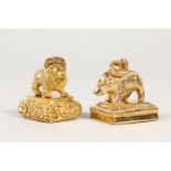 TWO GILT METAL FOB SEALS, modelled as a lion and boar. 1.25ins wide.