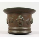 A SMALL 17TH CENTURY BRONZE MORTAR, the sides with putti and shells. 13cms diameter.