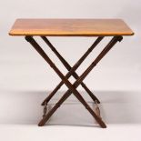 A 19TH CENTURY MAHOGANY TABLE, on folding legs. 2ft 10ins wide x 2ft 4ins high.