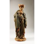 A PAINTED TERRACOTTA MODEL OF A MEDIEVAL LADY, 20th Century. 22ins high.