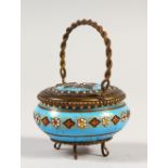 A SMALL ENAMEL DECORATED BASKET, with swing handle. 2.5ins wide.