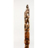 A CARVED WOOD CHIEF'S STAFF. 3ft 4ins long.