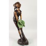AN AMUSING BRONZE FOUNTAIN, modelled as a pixie holding a bunch of lily pads. 30ins high.