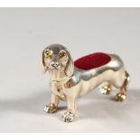 A NOVELTY SILVER DACHSHUND PIN CUSHION.