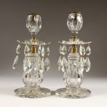 A GOOD PAIR OF VICTORIAN CUT GLASS CANDLESTICKS, with prism drops and circular bases. 11ins high.