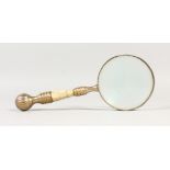 A MAGNIFYING GLASS, with ornate handle. 10ins long.