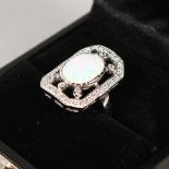 A SILVER AND GILSON OPAL RING.