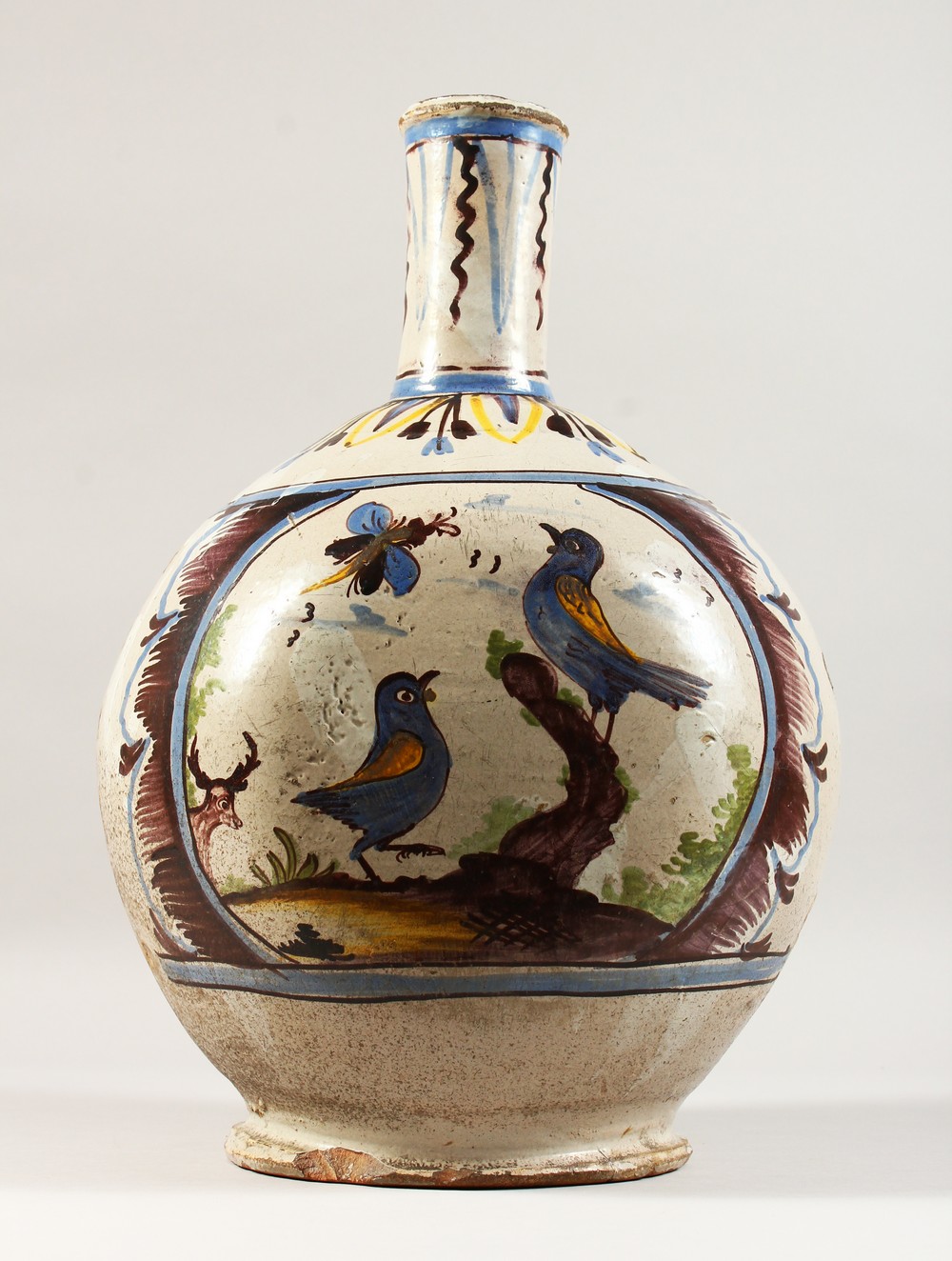 A LARGE CONTINENTAL POLYCHROME DECORATED TIN GLAZE FLASK, decorated with a Chinese figure and birds.