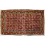 A SMALL PERSIAN RUG with stylized floral motifs. 4ft 7ins x 2ft 8ins.