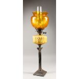 A CORINTHIAN COLUMN OIL LAMP, with opaque glass reservoir and shade. 21ins high (excluding shade).