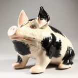 A LARGE GRISELDA HILL POTTERY WEMYSS BLACK AND WHITE PIG. 17ins long x 10.5ins high (some damage).