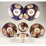 TWO COALPORT PORCELAIN TRIOS, blue and gilt ground with flowers.