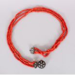 A LONG CORAL NECKLACE.