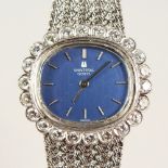 A LADIES UNIVERSAL 18CT WHITE GOLD AND DIAMOND WRISTWATCH AND BRACELET. No. 342555 3086067, in a
