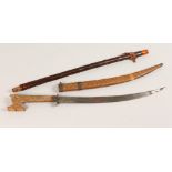 AN AFRICAN KNIFE, with carved wooden sheath and handle, and another item (2). Knife 19ins long.