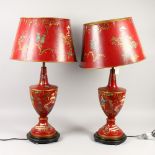 A PAIR OF TOLEWARE STYLE CHINOISERIE DECORATED URN SHAPE TABLE LAMPS. 30ins high.