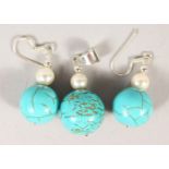 A SILVER AND TURQUOISE PENDANT AND EARRING SET.