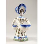 A CONTINENTAL TIN GLAZED FIGURAL DOUBLE SALT, modelled as a lady wearing a bonnet. 7.5ins high.