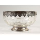 A CONTINENTAL SILVER AND CUT GLASS CIRCULAR BOWL, with engraved rim and footrim. 9ins diameter.
