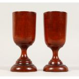 A PAIR OF MAHOGANY TURNED GOBLETS (splits). 5.5ins high.