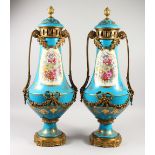 A LARGE PAIR OF SEVRES STYLE PORCELAIN AND ORMOLU TWIN HANDLED VASES AND COVERS, decorated with