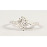 A 9CT GOLD TWO STONE DIAMOND CROSSOVER RING.