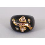 A BLACK ONYX AND DIAMOND RING.