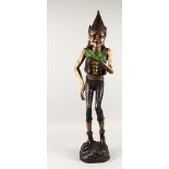 AN AMUSING BRONZE OF A WINGED PIXIE, holding a lily pad. 38ins high.