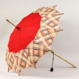 A LADIES' PARASOL, with turned and painted wood handle. 36ins long.