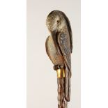 A LADIES' PARASOL, the wooden handle carved as a bird. 36ins long.