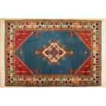 A PERSIAN RUG, turquoise ground with central diamond motif. 6ft 2ins x 3ft 11ins.