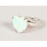 A SILVER AND OPAL HEART SHAPE RING.