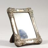 A SMALL REPOUSSE PHOTOGRAPH FRAME, Birmingham 1901. Maker AB & Co. 3.25ins high.