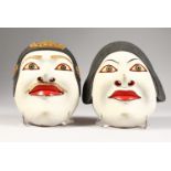 A PAIR OF CARVED WOOD AND PAINTED MASKS.