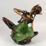AN AMUSING BRONZE OF A SEATED PIXIE, with a lily pad between its feet. 16ins high.