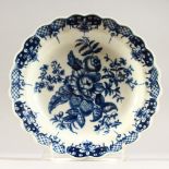 A WORCESTER BLUE AND WHITE CIRCULAR PLATE with scalloped edge, crescent mark in blue. 7ins