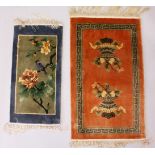 A CHINESE RUG, rust ground decorated with two urns; together with a Chinese mat. 2ft 7ins x 1ft
